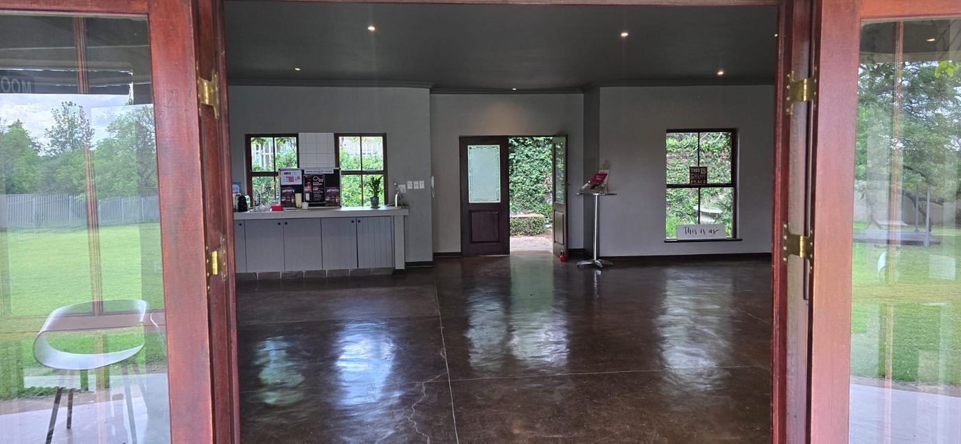 The indoor hall at the Chartwell venue, with polished concrete floors and doors opening onto the garden