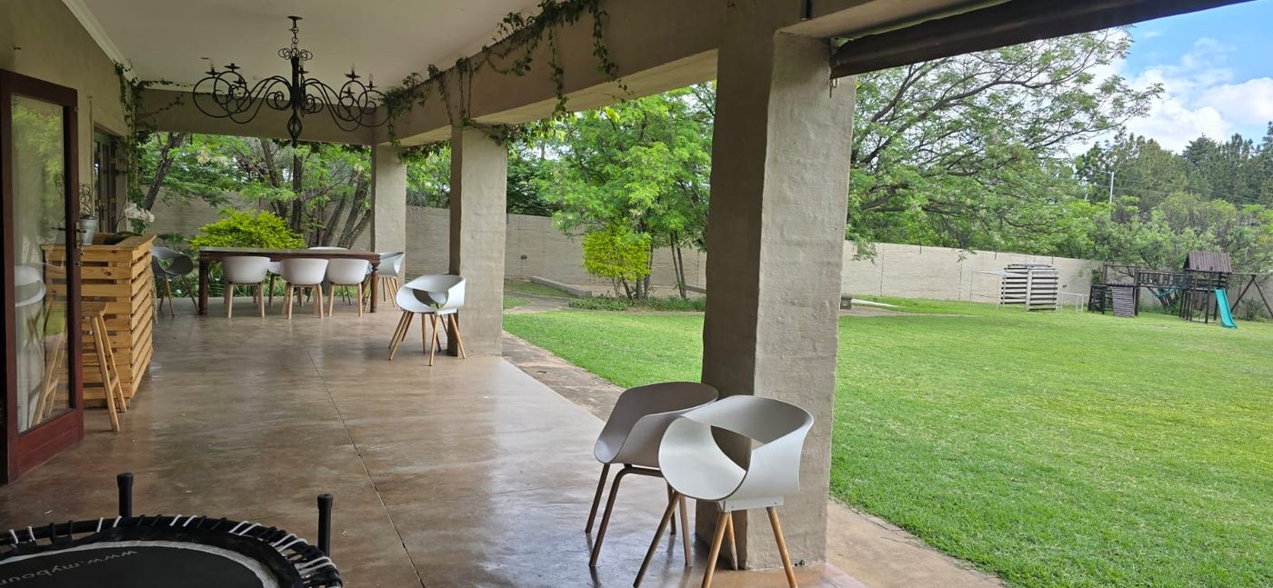 Covered patio with seating looking out over the lawn